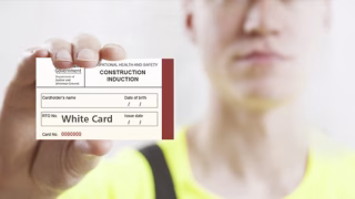 construction worker holding a white card asking the question does a white card ever expire in Australia?